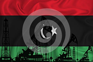 Developing Flag of Libya. Silhouette of drilling rigs and oil rigs on a flag background. Oil and gas industry. The concept of oil