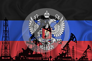 Developing Flag ofDonetsk People`s Republic. Silhouette of drilling rigs and oil rigs on a flag background. Oil and gas industry.