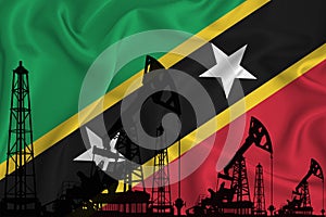 Developing Flag of saint kitts. Silhouette of drilling rigs and oil rigs on a flag background. Oil and gas industry. The concept