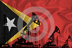 Developing Flag of timor. Silhouette of drilling rigs and oil rigs on a flag background. Oil and gas industry. The concept of oil