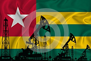 Developing Flag of togo. Silhouette of drilling rigs and oil rigs on a flag background. Oil and gas industry. The concept of oil