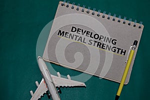 Developing Mental Strength write on a book isolated on Office Desk