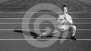 Developing physical fitness. Teenage girl stand in lunge position. Physical educaiton. Sports school
