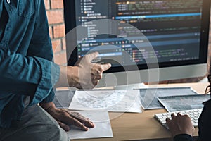 Developing programming and coding technologies working in a software engineers developing applications together in office