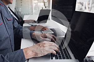 Developing programming and coding technologies working in a software engineers developing applications together in office