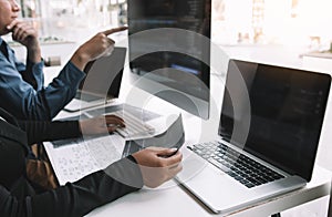Developing programming and coding technologies working in a software engineers developing applications together in office