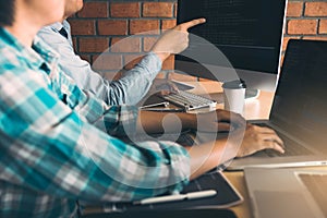 Developing programming and coding technologies working in a software engineers developing applications together in office