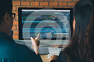 Developing programming and coding technologies working in a software engineers developing applications together in office