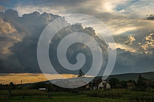 Developing storm clouds over the Transylvanian landscape at sunset