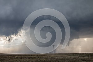 A developing tornado is shrouded by curtains of rain.