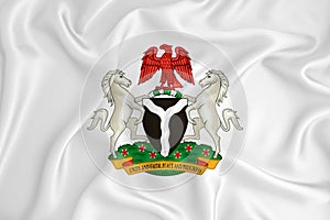 A developing white flag with the coat of arms of Nigeria. Country symbol. Illustration. Original and simple coat of arms in