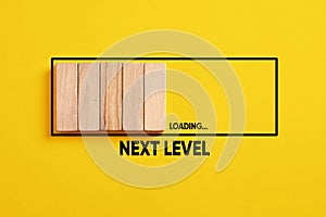 Development, improvement. Completing a task and moving forward to the next level. Next level loading bar on yellow background