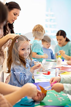 Development learning children in art class. Children`s project in kindergarten. Group of kids with teacher together.