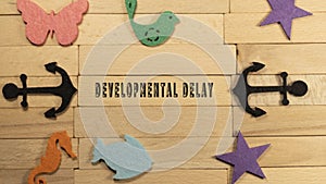 Developmental delay inscribed on wood patterned surface. Education and child psychology