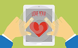Device with heart on the screen holding in hands