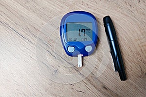 The device for measuring blood sugar lies on the table. Very low blood sugar (hypoglycemia). Copy space.