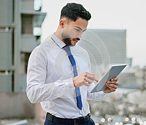Devices keep bringing me disappointment. Shot of a young businessman using a digital tabley.