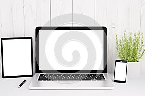 devices on table with blank screen