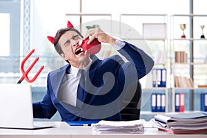 The devil angry businessman in the office