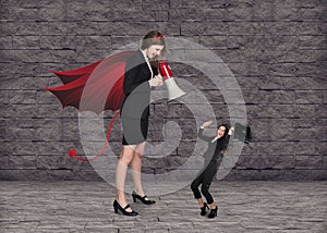 Devil businesslady with a megaphone screeming photo