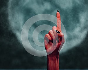 Devil hand pointing upward