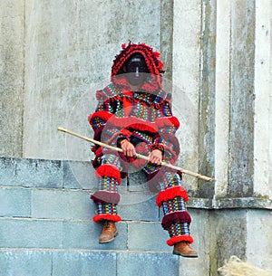 a devil of Portugal sit on wall photo