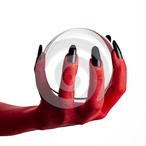 Devil's hand holding crystal ball.