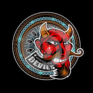 Devil`s head in center of motorcycle wheel, color label on black background