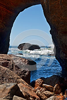 Devil`s Punchbowl cave looking out into Pacific Ocean waves