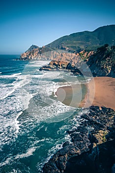 Devil`s Slide sheer cliffs and pacific coast in San Mateo County photo