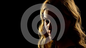 Devil woman looking at camera, black background, paranormal mystery, white eyes