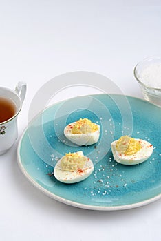 Deviled eggs on a blue plate