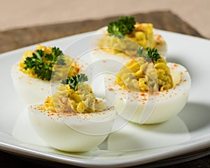 Deviled eggs garnished with parsley and paprika