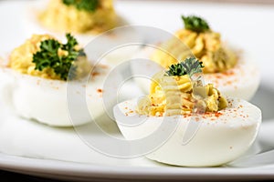 Deviled eggs garnished with parsley and paprika