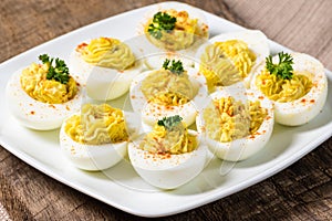 Deviled eggs garnished with parsley and paprika