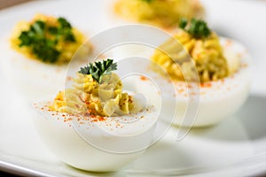 Deviled eggs garnished with parsley and paprika