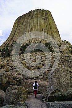 Devils Tower In Wyoming With Female Hiker At Base