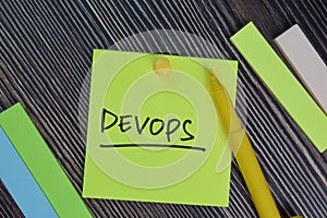 Devops write on sticky notes isolated on office desk
