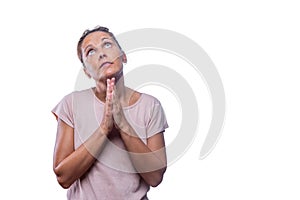A devoted adult woman praying with hands clasped