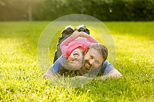 Devoted father and daughter lying on grass