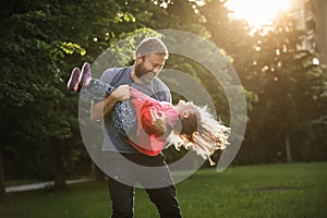 Devoted father spinning his daughter in circles