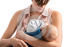 Devoted young mother breastfeeding her newborn baby