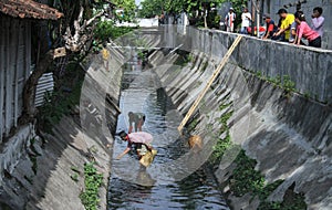 Devotedly residents clean up the river in the city of Solo in Central Java Indonesia