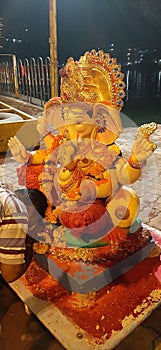 A devotee and Lord Ganesha idol during emersion