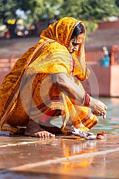 devotee praying for holy god after bathing in holy river water at morning from flat angle photo