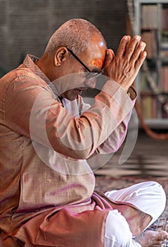 devotee praying for holy god at temple at morning from flat angle photo