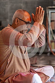 devotee praying for holy god at temple at morning from flat angle photo