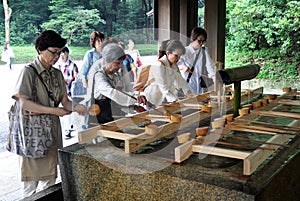 Devotees performing harai before worship at Meiji Shrine, Tokyo, Japan