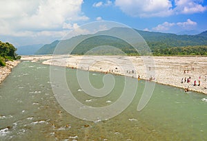 Devotees taking bath in himalayan river photo
