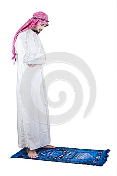 Devout Arabic man praying in studio